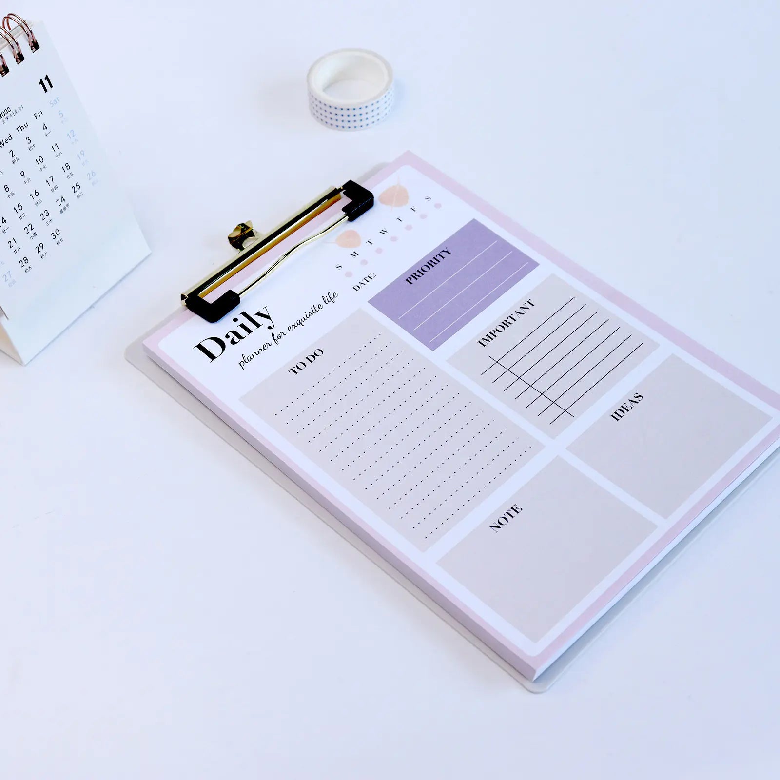 Daily planner with sections for tasks, ideas, and notes on a white surface.